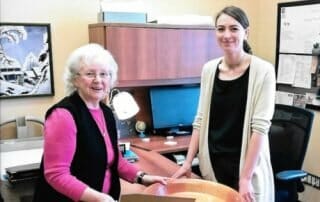 Ellen Edwards (daughter of John Tompson) and Kristin Hardie, archivist, examine the bowl